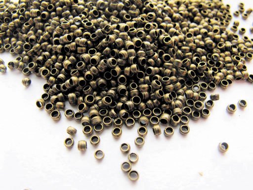 Förpackning med 60 bronsfärgade klämpärlor 2 mm Förpackning med 60 bronsfärgade klämpärlor 2 mm